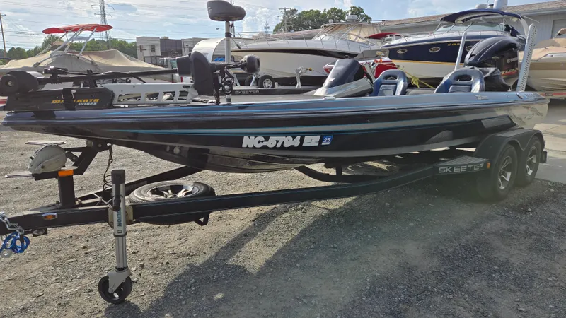 Slide: The Image of 2017 Skeeter ZX 250 boat on trailer, parked outdoors at a marina. - 2