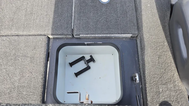 Slide: The Image of 2017 Skeeter ZX 250 boat storage compartment with open hatch and accessories inside. - 31