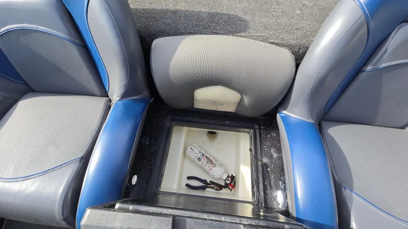 Slide: The Image of 2017 Skeeter ZX 250 boat interior with storage compartment, fire extinguisher, and pliers. - 39