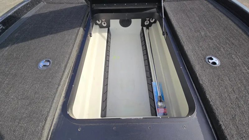 Slide: The Image of 2017 Skeeter ZX 250 boat storage compartment with carpeted deck and open hatch. - 40