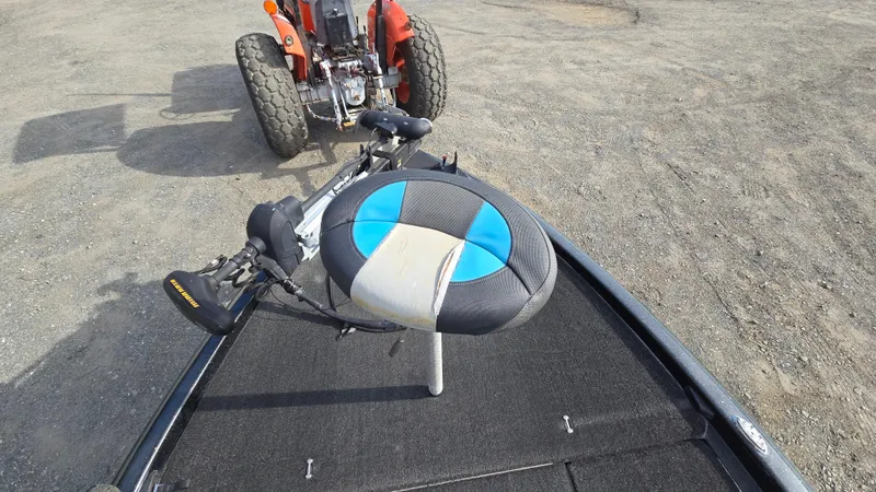 Slide: The Image of 2017 Skeeter ZX 250 boat with blue and black seat, parked on gravel. - 45