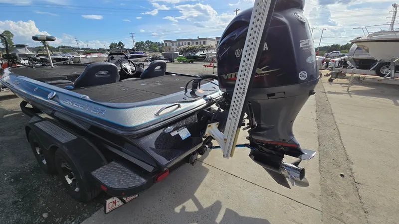 Slide: The Image of 2017 Skeeter ZX 250 boat with Yamaha engine, parked outdoors under a clear sky. - 5