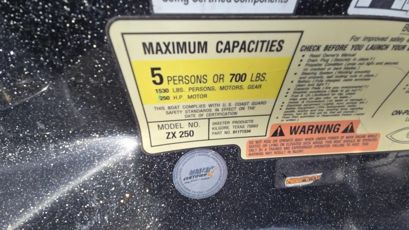 Slide: The Image of 2017 Skeeter ZX 250 capacity label, maximum 5 persons or 700 lbs, safety warnings included. - 54