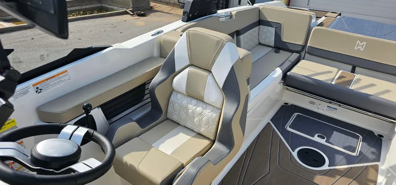 Slide: The Image of 2025 Heyday H22 boat interior with beige and gray seating, modern steering wheel, and stylish design. - 11