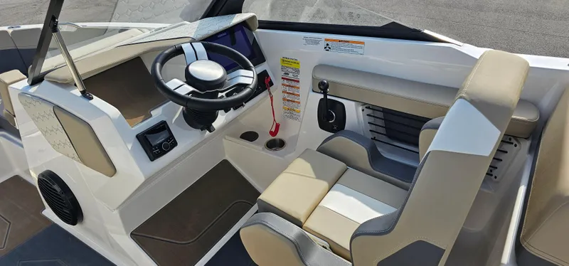 Slide: The Image of 2025 Heyday H22 boat cockpit with modern steering wheel and comfortable seating. - 12