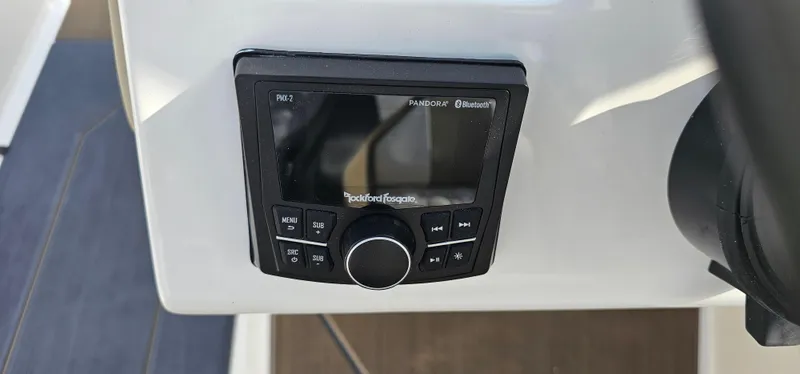 Slide: The Image of Rockford Fosgate audio system on 2025 Heyday H22 boat dashboard. - 13