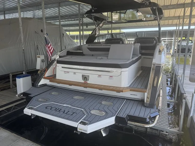 Slide: The Image of 2026 Cobalt R35 boat docked, featuring spacious seating and sleek design. - 2