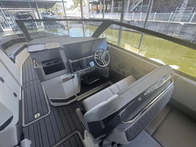 Slide: The Image of Interior of a 2026 Cobalt R35 boat, featuring a modern helm and seating area. - 9