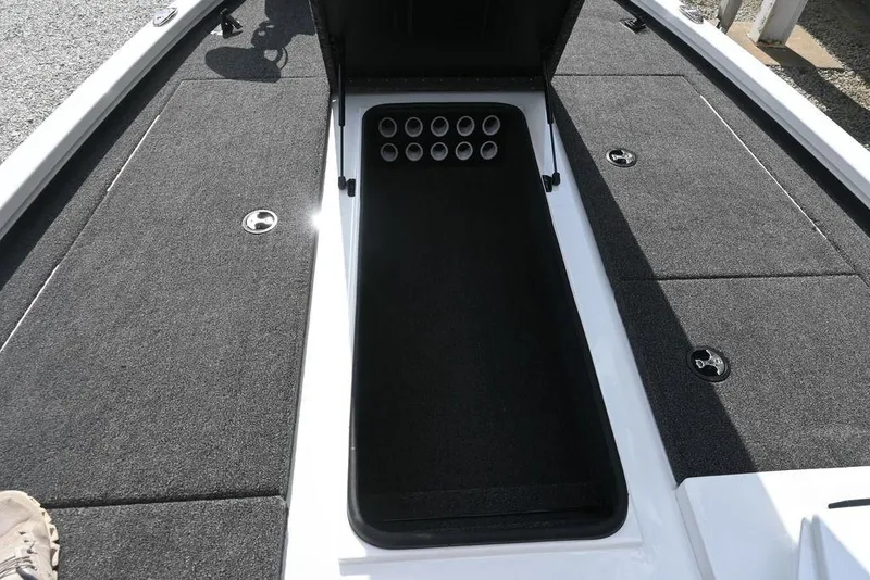Slide: The Image of 2021 Vexus AVX2080 boat interior with rod storage compartment and carpeted deck. - 13