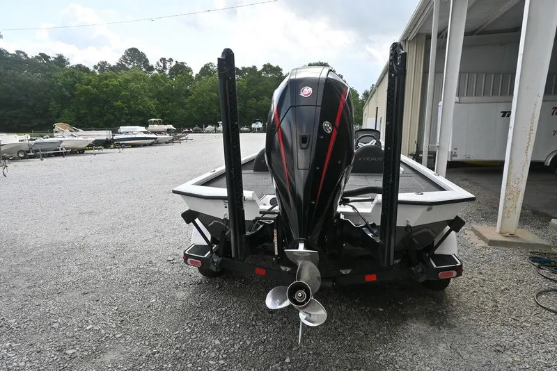 Slide: The Image of 2021 Vexus AVX2080 boat with powerful outboard motor in a marina setting. - 2