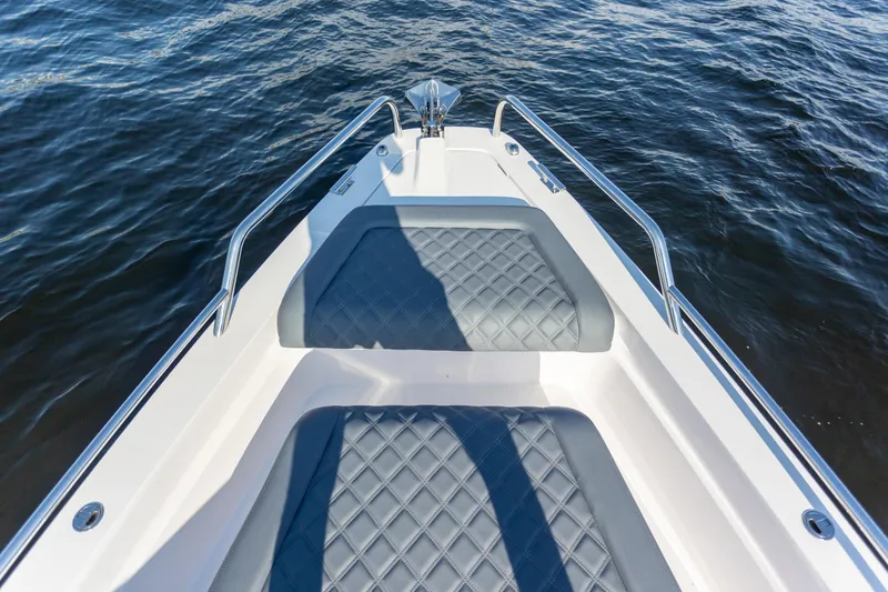 Slide: The Image of Bow seating area of 2021 Axopar 37XC Aft Cabin on water. - 10