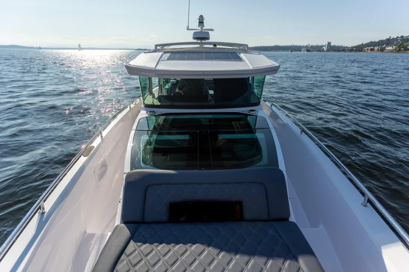 Slide: The Image of Axopar 37XC Aft Cabin 2021 cruising on a sunny day, showcasing sleek design and comfort. - 11