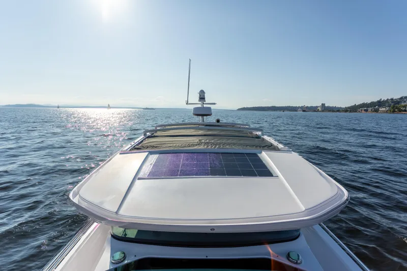 Slide: The Image of 2021 Axopar 37XC Aft Cabin cruising on a sunny day, featuring a solar panel. - 12