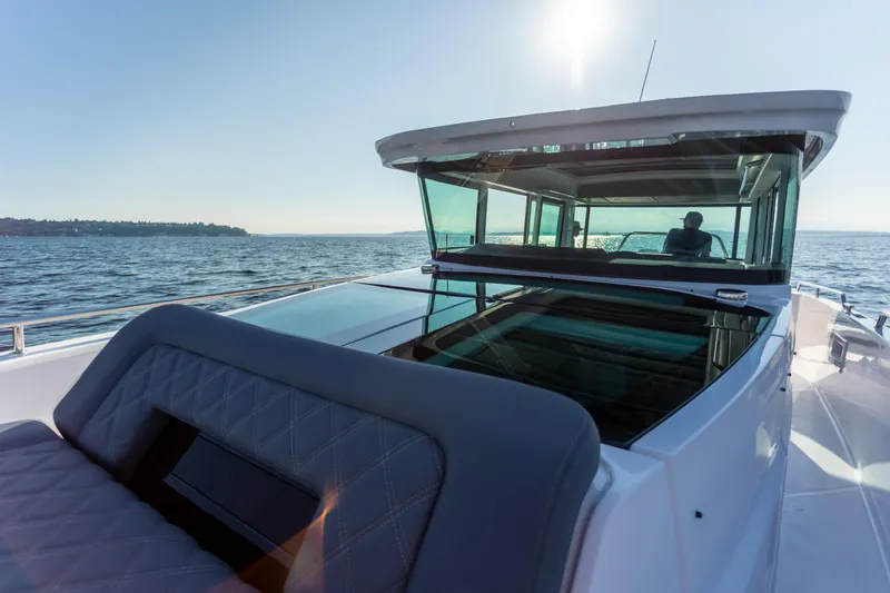 Slide: The Image of 2021 Axopar 37XC Aft Cabin cruising on open water under clear skies. - 14