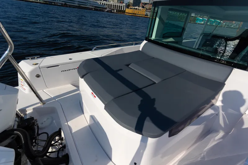 Slide: The Image of 2021 Axopar 37XC Aft Cabin boat on water, featuring sleek design and spacious deck. - 16