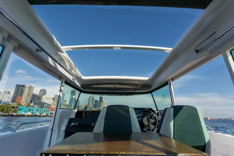 Slide: The Image of Interior view of 2021 Axopar 37XC Aft Cabin with city skyline in background. - 25