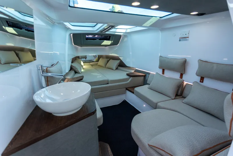 Slide: The Image of Luxurious interior of 2021 Axopar 37XC Aft Cabin with modern seating and skylight. - 28