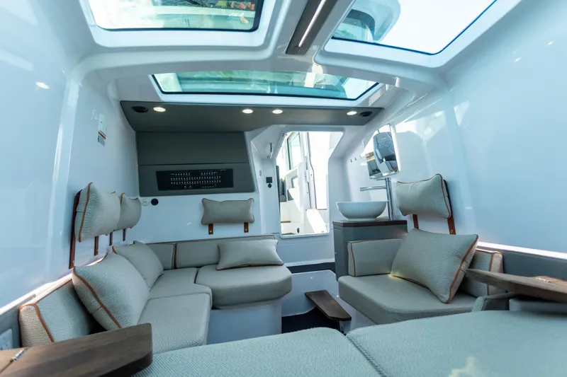 Slide: The Image of Luxurious interior of 2021 Axopar 37XC Aft Cabin with modern seating and skylight. - 30
