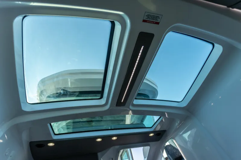 Slide: The Image of Sunroof view inside 2021 Axopar 37XC Aft Cabin, showcasing modern design and natural light. - 31