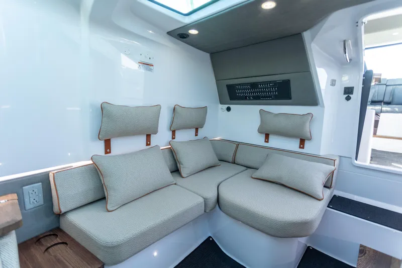 Slide: The Image of 2021 Axopar 37XC Aft Cabin interior with cushioned seating and modern design. - 32