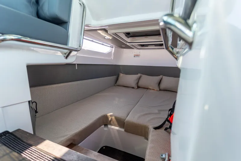 Slide: The Image of 2021 Axopar 37XC Aft Cabin interior with cozy seating and cushions. - 36