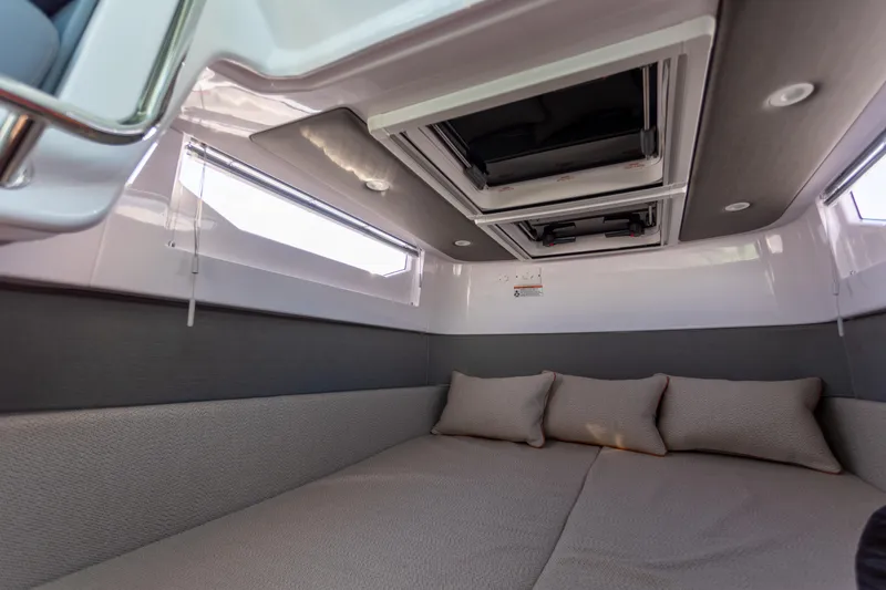 Slide: The Image of Interior of 2021 Axopar 37XC Aft Cabin, featuring cozy bedding and modern design. - 37