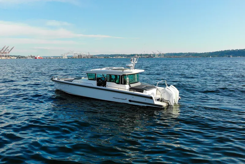 Slide: The Image of 2021 Axopar 37XC Aft Cabin boat cruising on open water. - 4