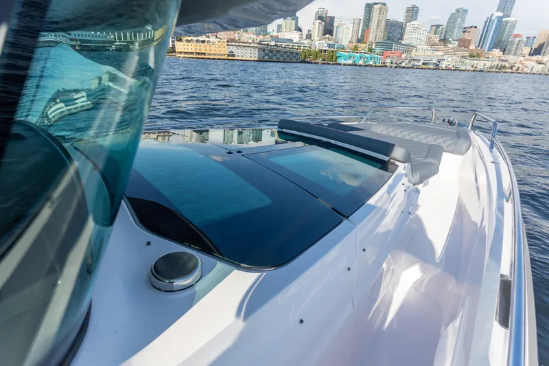 Slide: The Image of 2021 Axopar 37XC Aft Cabin boat cruising near city skyline. - 8