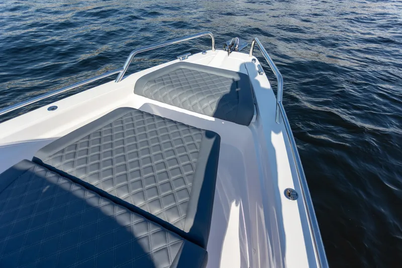 Slide: The Image of Bow seating area on 2021 Axopar 37XC Aft Cabin, featuring quilted cushions. - 9