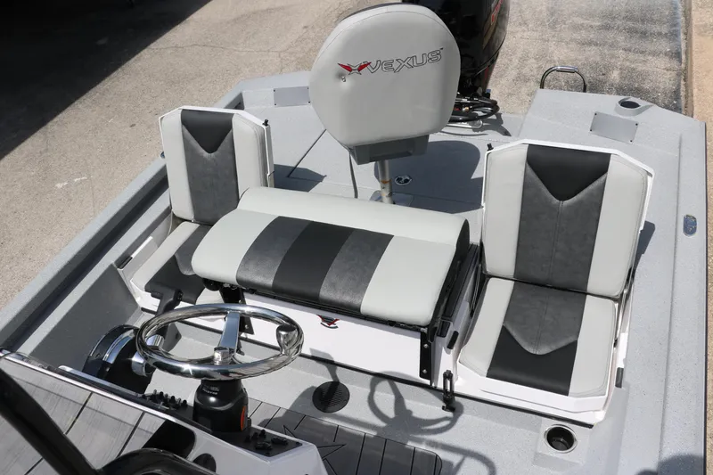 Slide: The Image of 2025 Vexus ACX 2000 boat interior with gray and black seating and steering wheel. - 20