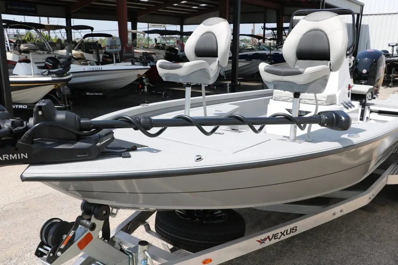 Slide: The Image of 2025 Vexus ACX 2000 boat with dual seats and Garmin equipment in a showroom. - 29