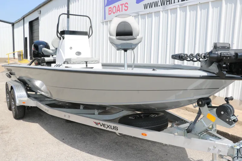Slide: The Image of 2025 Vexus ACX 2000 boat on trailer, parked outside a building. - 5