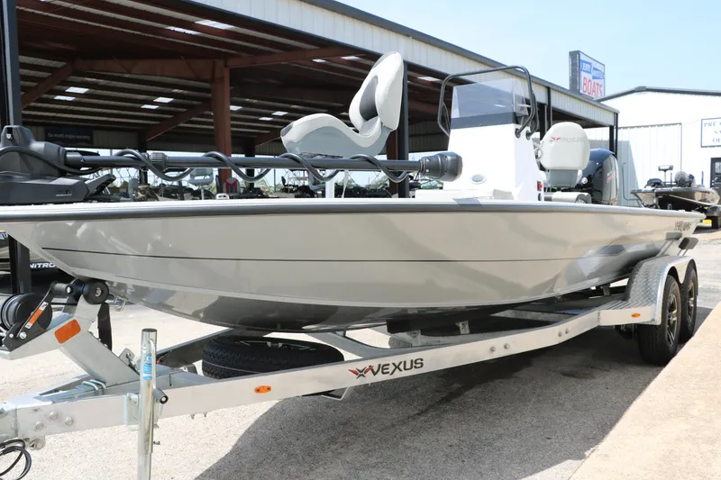 Slide: The Image of 2025 Vexus ACX 2000 boat on trailer, displayed outdoors at a dealership. - 6