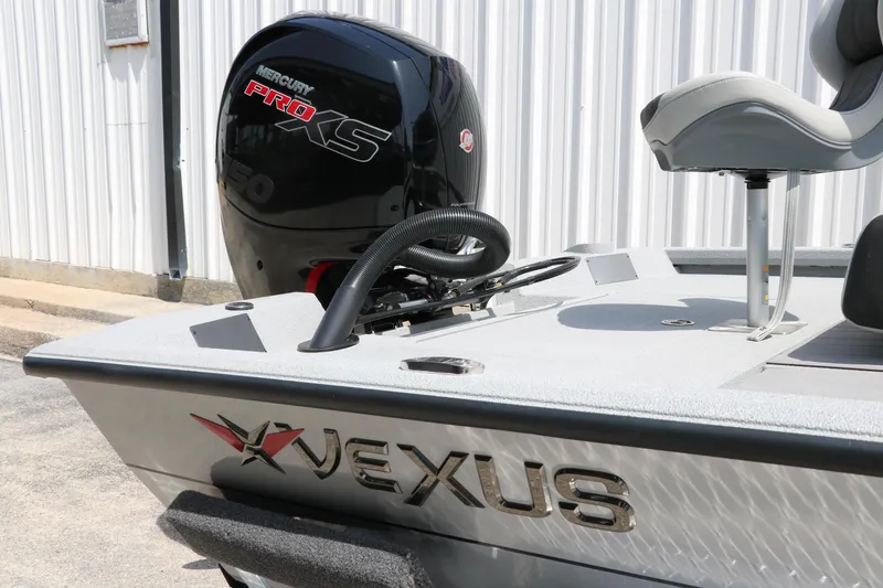 Slide: The Image of 2025 Vexus ACX 2000 boat with Mercury Pro XS engine, docked near a white building. - 9