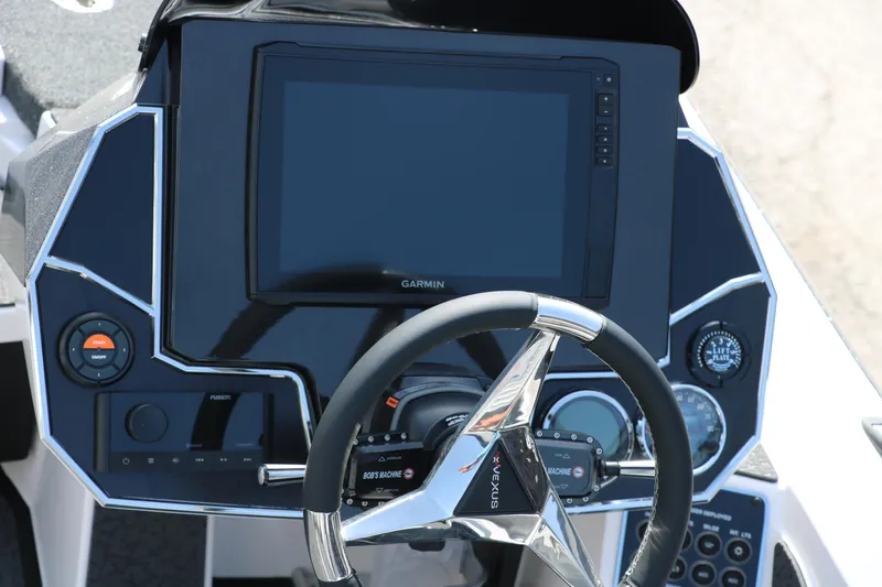Slide: The Image of 2025 Vexus VXS 21 boat dashboard with steering wheel and Garmin display. - 14