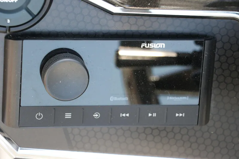 Slide: The Image of Control panel of a 2025 Vexus VXS 21 boat featuring a Fusion audio system. - 30