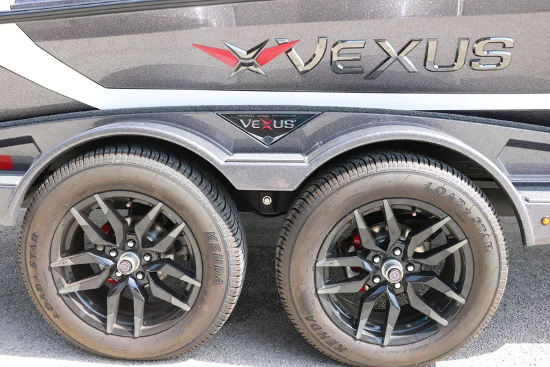 Slide: The Image of 2025 Vexus VXS 21 trailer with dual black alloy wheels and branded logo. - 36