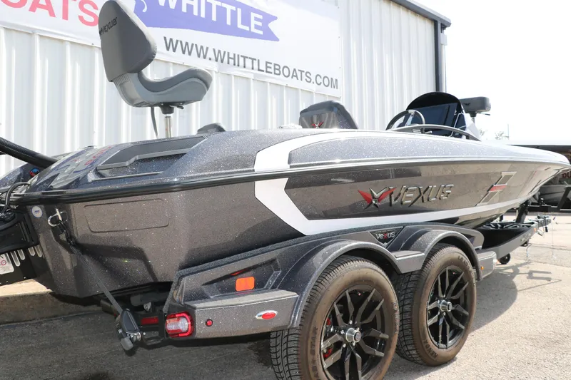 Slide: The Image of 2025 Vexus VXS 21 boat on trailer, displayed at Whittle Boats dealership. - 9