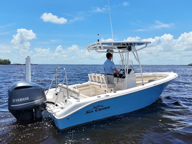 Slide: The Image of 2021 Carolina Skiff Sea Chaser 22 HFC boat on a calm lake under a blue sky. - 0