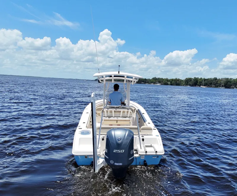 Slide: The Image of 2021 Carolina Skiff Sea Chaser 22 HFC boat on open water under blue sky. - 11