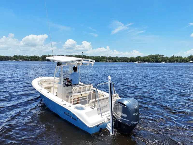 Slide: The Image of 2021 Carolina Skiff Sea Chaser 22 HFC cruising on open water under blue sky. - 12