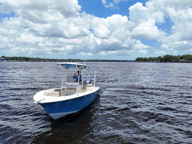 Slide: The Image of 2021 Carolina Skiff Sea Chaser 22 HFC boat on a sunny day, cruising on a lake. - 14