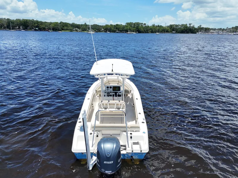 Slide: The Image of 2021 Carolina Skiff Sea Chaser 22 HFC boat on calm blue water. - 18