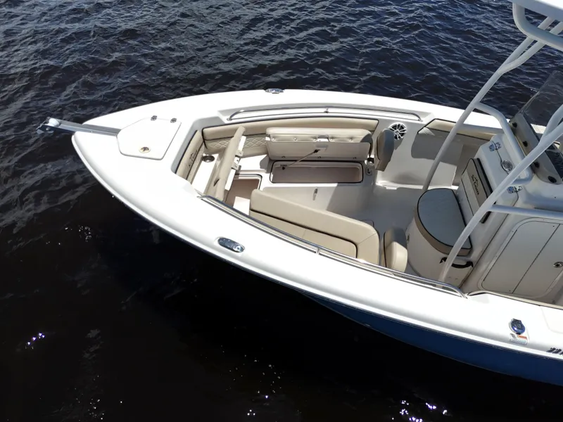 Slide: The Image of 2021 Carolina Skiff Sea Chaser 22 HFC boat on water, featuring spacious seating and sleek design. - 23