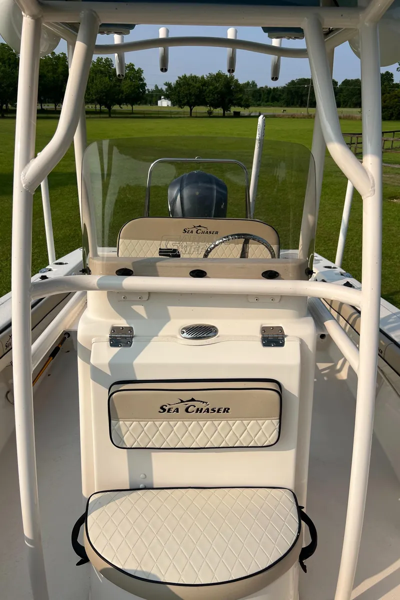 Slide: The Image of 2021 Carolina Skiff Sea Chaser 22 HFC boat interior with seating and console. - 26
