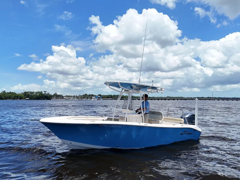 Slide: The Image of 2021 Carolina Skiff Sea Chaser 22 HFC boat on open water, clear sky background. - 3