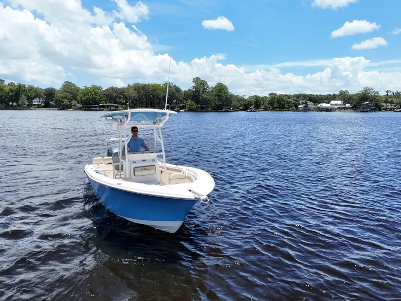 Slide: The Image of 2021 Carolina Skiff Sea Chaser 22 HFC boat cruising on a scenic lake. - 5