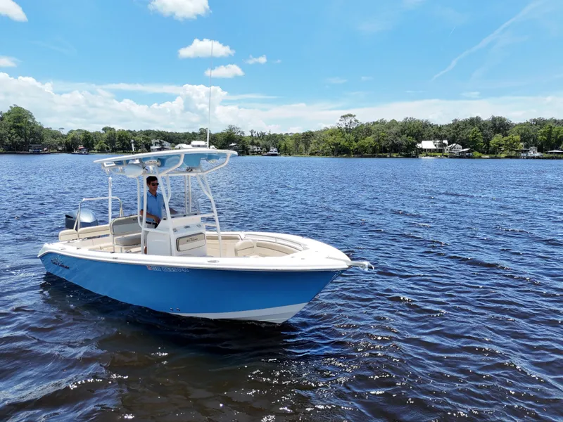 Slide: The Image of 2021 Carolina Skiff Sea Chaser 22 HFC boat on water under blue sky. - 6