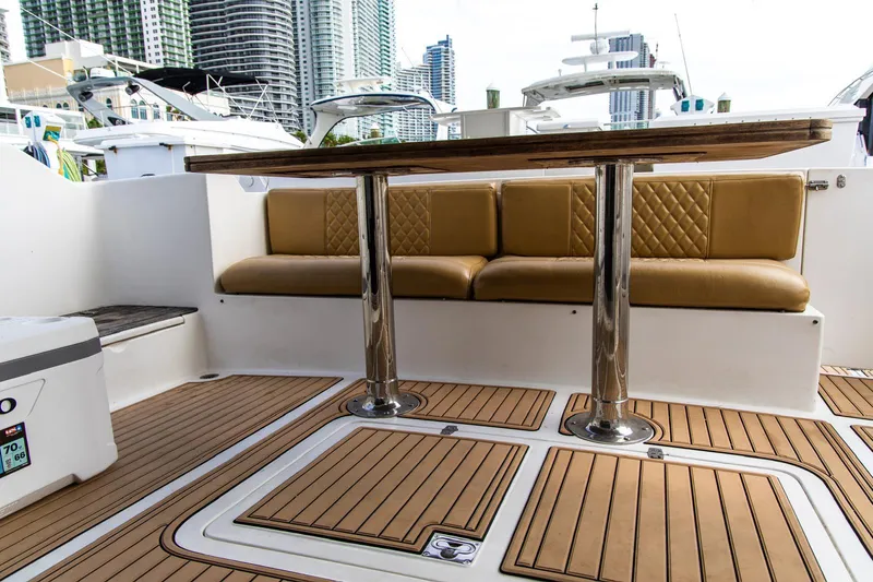 Slide: The Image of Luxurious 2002 Dyna 50 yacht interior with cushioned seating and wooden flooring. - 13