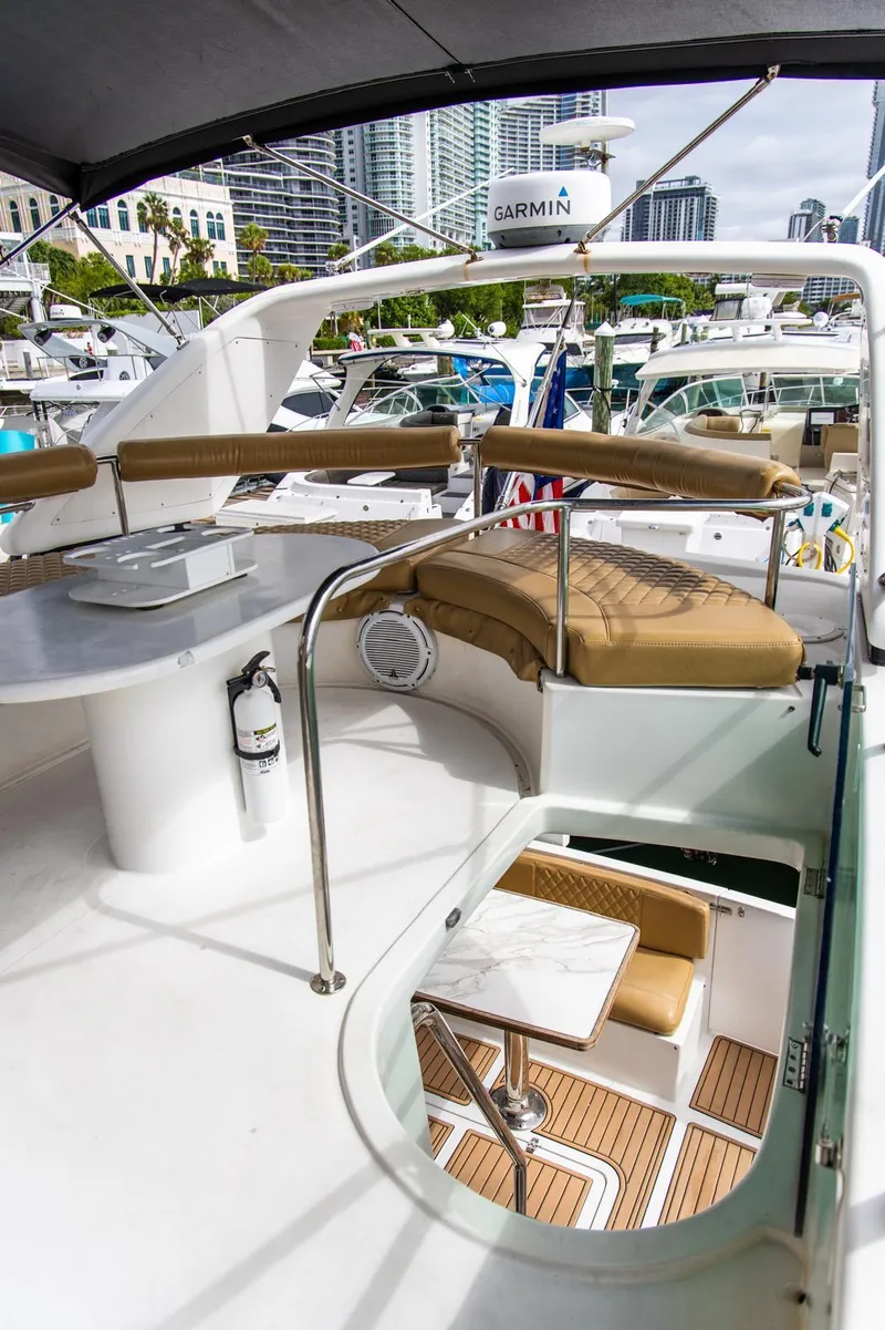 Slide: The Image of Luxurious 2002 Dyna 50 yacht interior with seating, table, and cityscape view. - 18